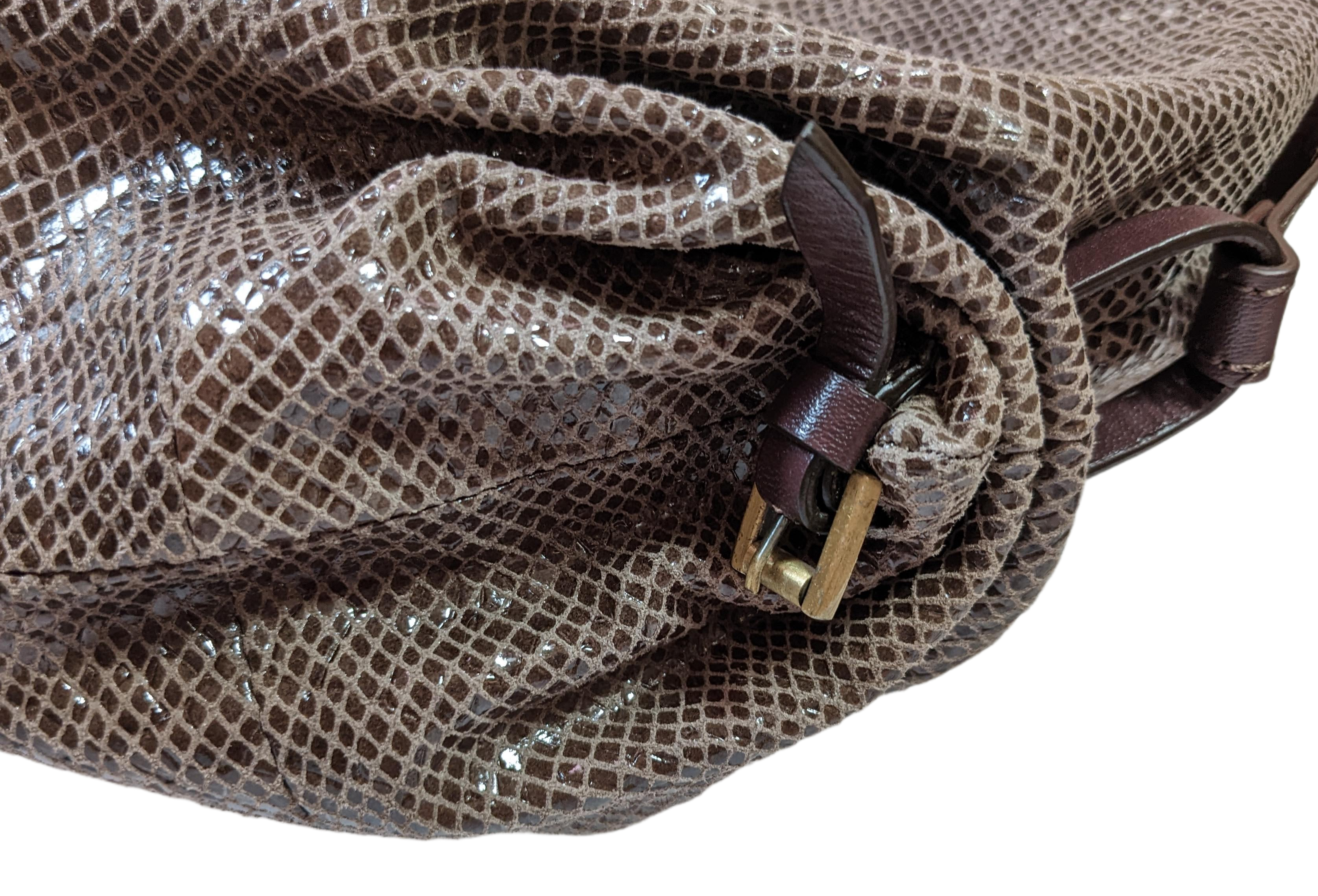 orYany Embossed Leather Handbag Elevate your style with the orYany Embossed Leather Handbag. Crafted with luxurious snake skin embossed leather, this beautiful taupe