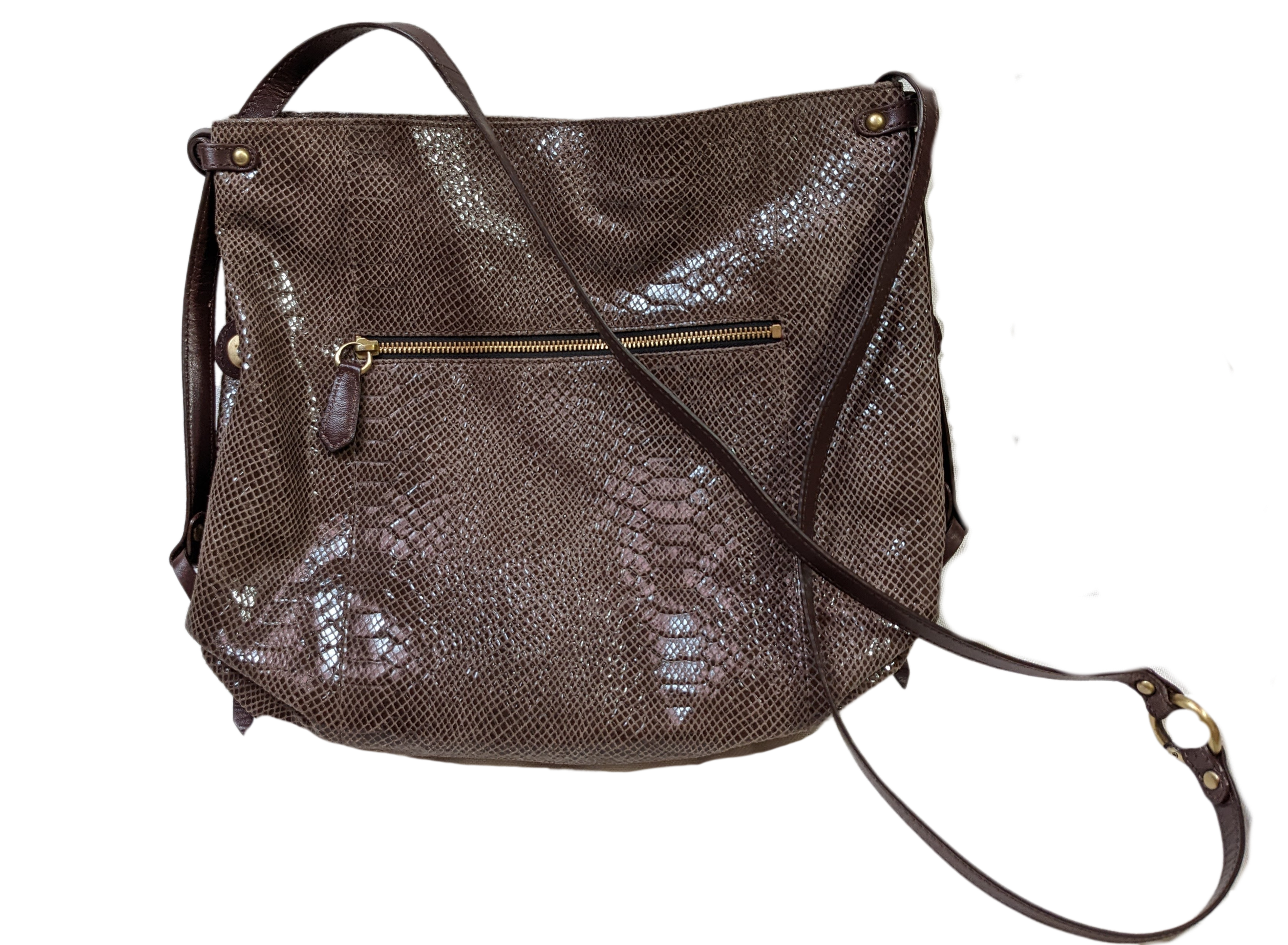 orYany Embossed Leather Handbag Elevate your style with the orYany Embossed Leather Handbag. Crafted with luxurious snake skin embossed leather, this beautiful taupe