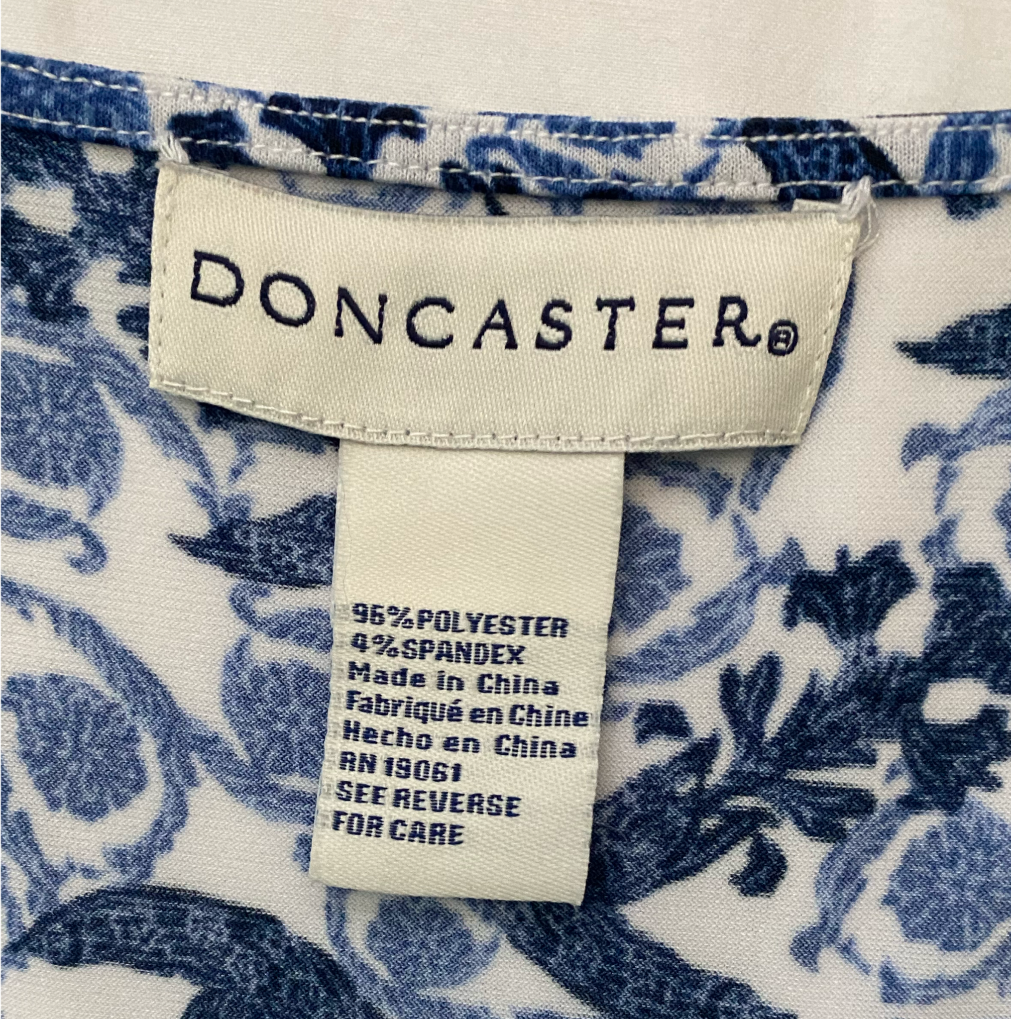 Doncaster Blue Print Sleeveless Top Doncaster blue print stretch sleeveless top with rouged/ruffled center front.