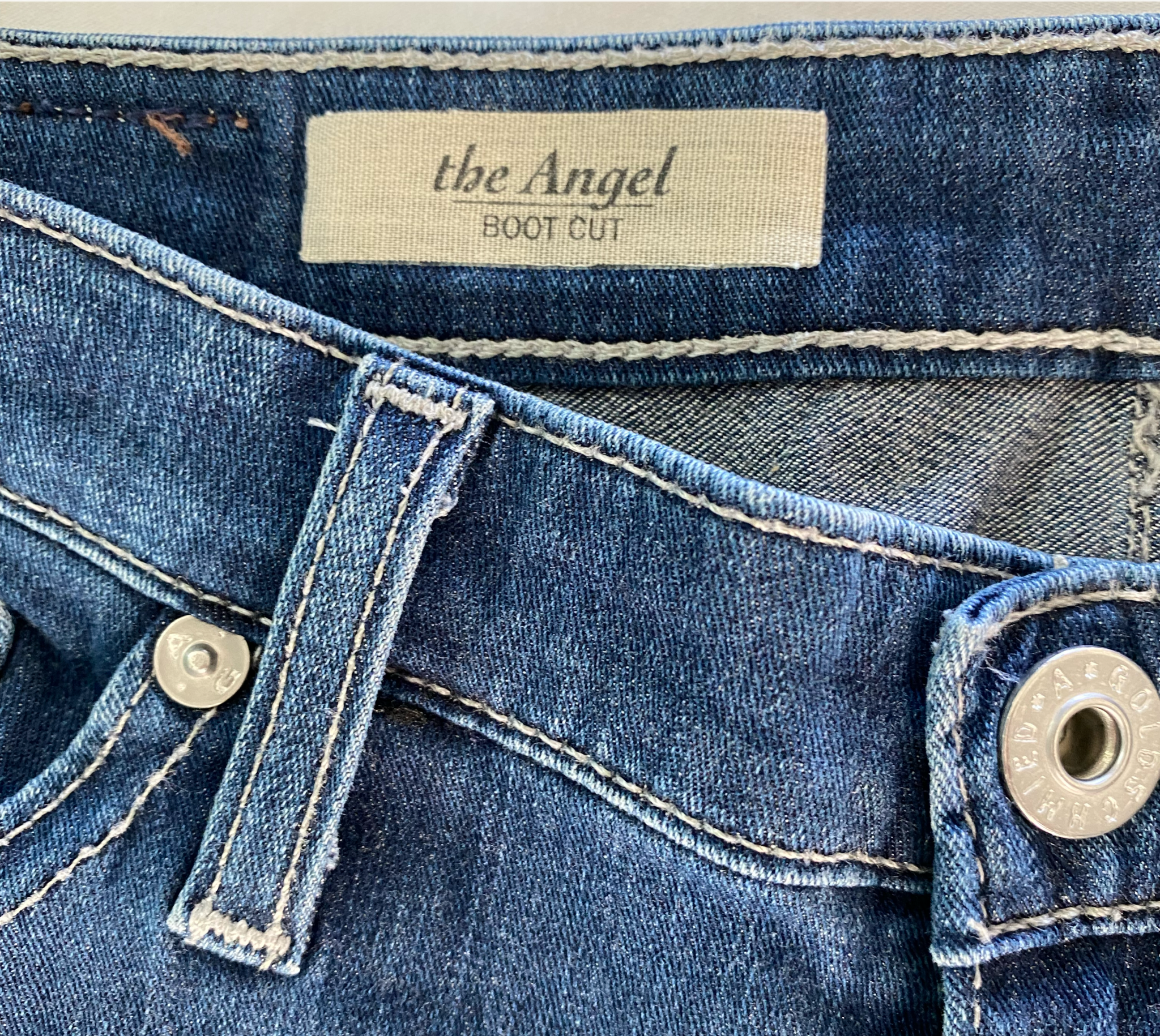 AG - Adriano Goldschmied The Angel Boot Cut Jeans Size 27R A dark-yet-bright indigo wash adds everyday sophistication to low-rise, full-length bootcut jeans made fro