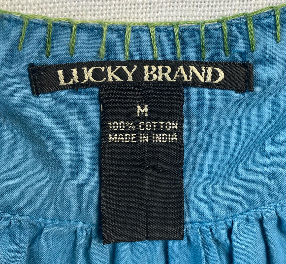 Lucky Brand Blue Babydoll Style Tank TopThis strappy little tank has cute tie straps and a green trim around the neck.