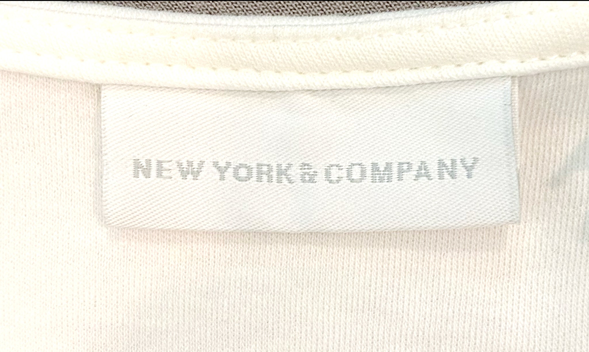 New York and Company White Fit and Flare Dress New York and Company white sleeveless fit and flare dress with black band at bottom.